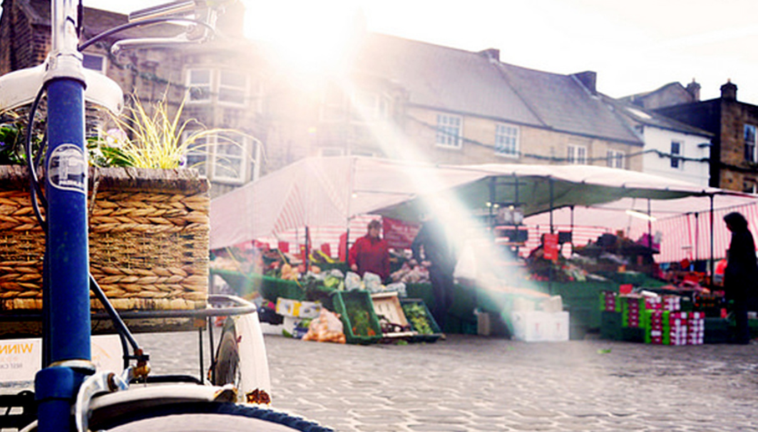 Image of a bike on Otley Market Place with the sun shining through